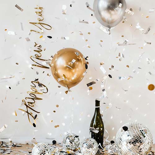 It's a festive New Year scene decoration with "Happy New Year" lettering, gold and silver balloons, confetti, disco balls.